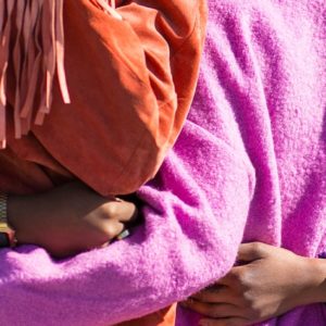 four women embracing showing the trait of caring for one another