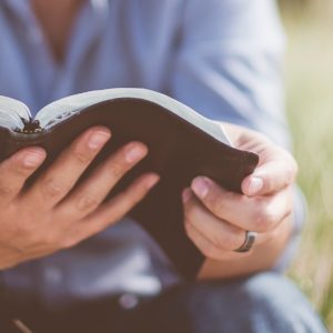 man reading Bible ten commandments God's name