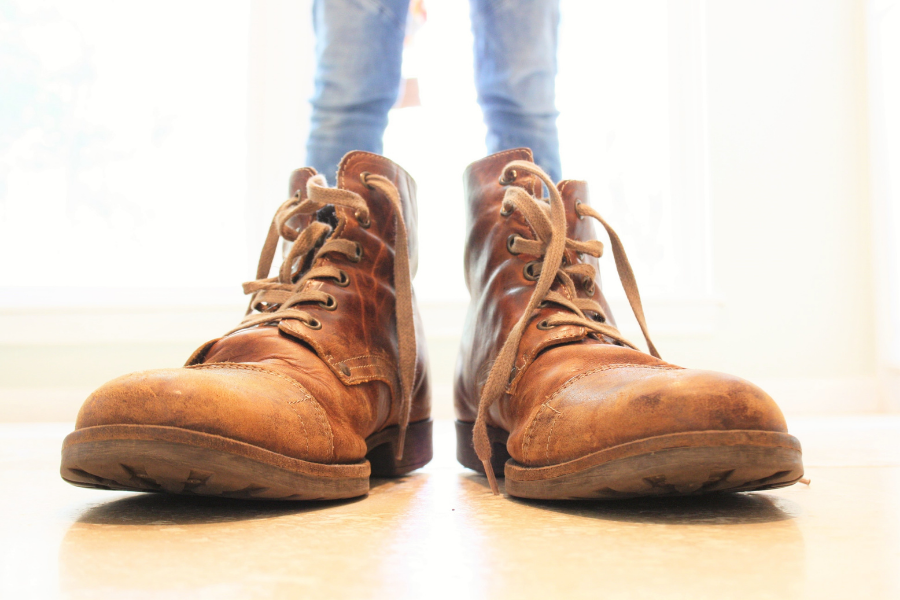 A worn out pair of brown leather boots