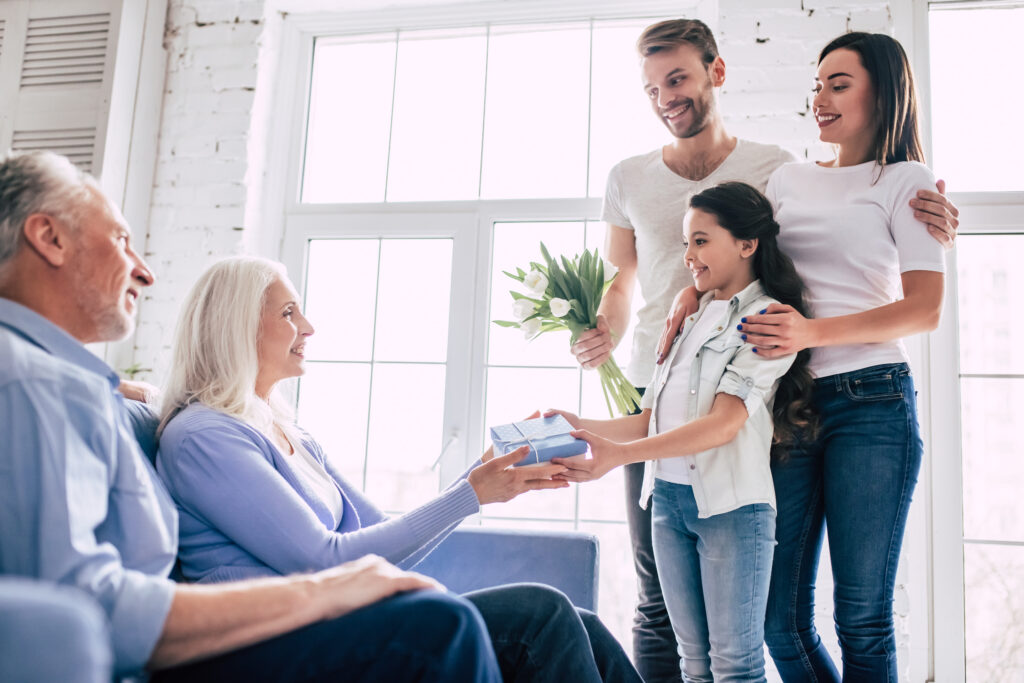 7 Bible Verses about Generosity-happy girl receiving gift from parents