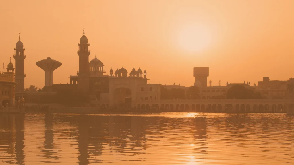 Landscape of city skyline in India, showing a reflection on water.