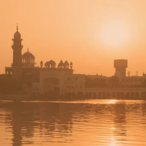 Landscape of city skyline in India, showing a reflection on water.