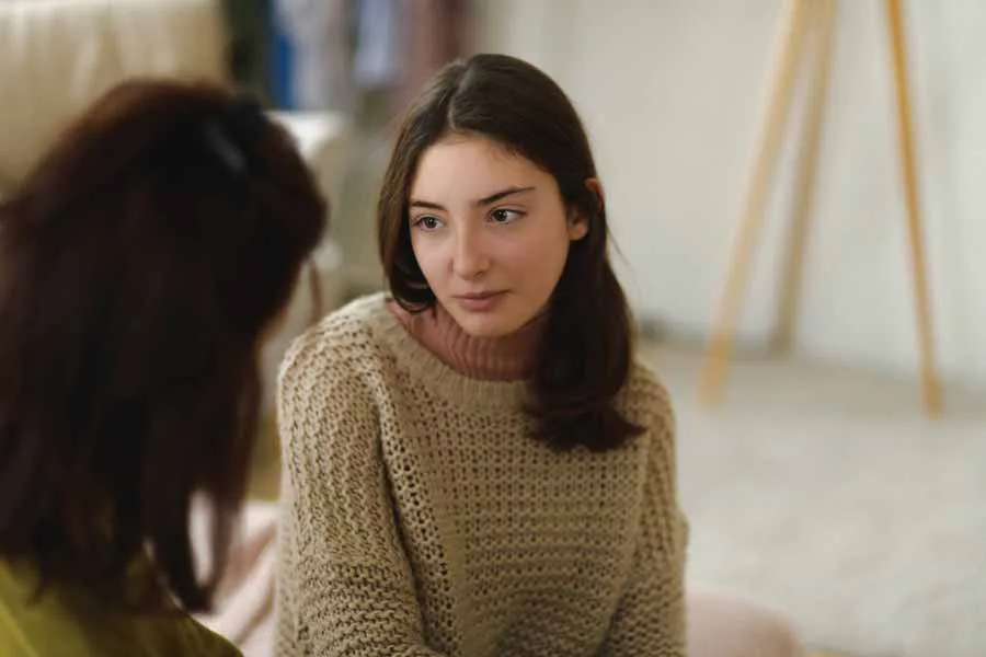 Young woman listening to her friend in conversation